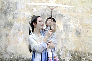 Happy family time, Chinese classic woman in Hanfu dress with baby girl