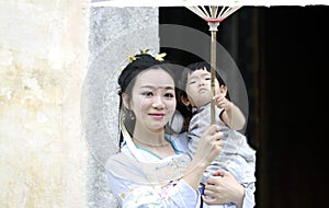 Happy family time, Chinese classic woman in Hanfu dress with baby girl