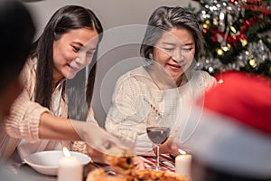 Happy family time and relationship, Asian big family having small party eating food at home. Grandparent is happy to see his child