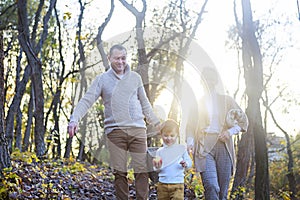 Happy family together on autumn picnic in the evening