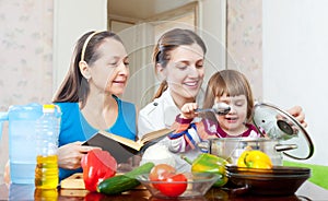 Happy family together cook with cookbook