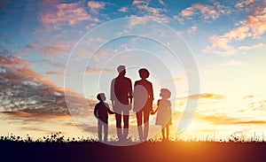 Happy family together at sunset. Parents with their children