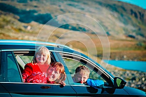 Happy family travel by car in mountains