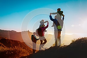 Happy family travel in mountains at sunset