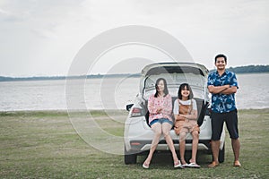 Happy family traveling on holiday by car. Parents and daughter spend free time together