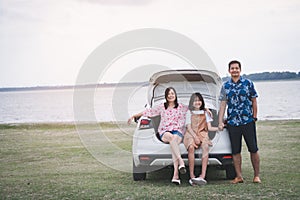 Happy family traveling on holiday by car. Parents and daughter spend free time together