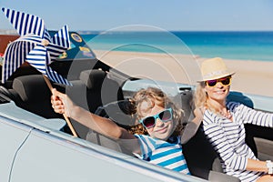 Happy family travels by car on summer vacation