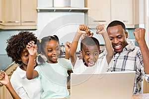 Happy family triumphing in the kitchen