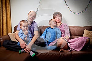 Happy family with two children cheerfully spend house time before Christmas