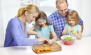 Happy family with two kids cooking at home