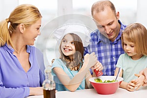 Happy family with two kids eating at home