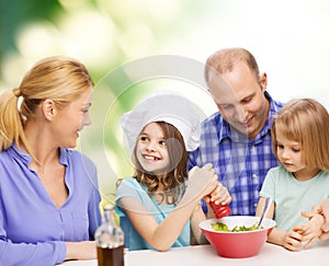 Happy family with two kids eating at home