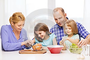 Happy family with two kids making dinner at home