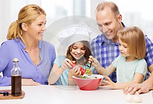 Happy family with two kids making dinner at home