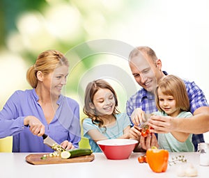 Happy family with two kids making dinner at home