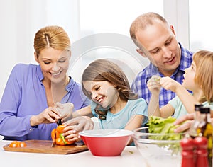 Happy family with two kids making dinner at home