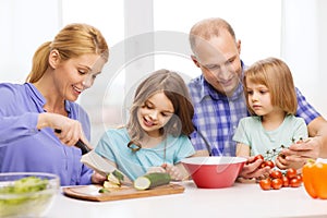 Happy family with two kids making dinner at home