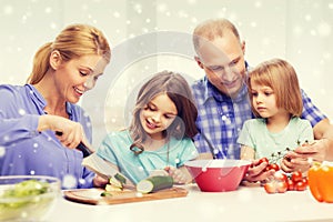 Happy family with two kids making dinner at home