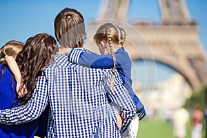 Happy family with two kids near Eiffel tower on