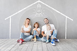 Happy family with two kids playing into new home