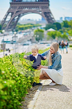 Happy family of two in Paris near the Eiffel tower