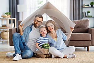 Happy family under fake roof in living room