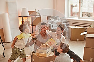 Happy Family Unpacking Box in New House