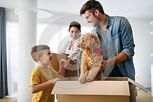 Happy family unpacking boxes in new home on moving day