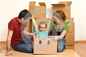 Happy family unpacking in their new home photo