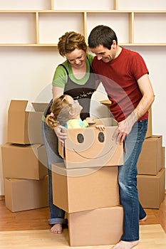 Happy family unpacking in their new home