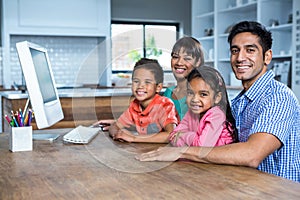 Happy family using computer in the kitchen