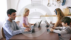 Happy family using electronic device at home