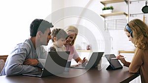 Happy family using electronic device at home