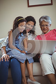 Happy family using laptop in living room