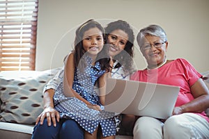 Happy family using laptop in living room