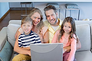 Happy family using the laptop together