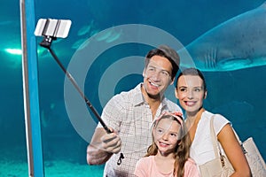 Happy family using selfie stick