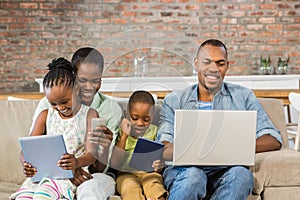 Happy family using technology together