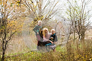 Happy family during walk in autumn forest