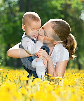 Happy family on a walk. mother kissing baby