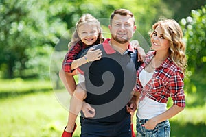 Happy family on a walk in Park in the summer.