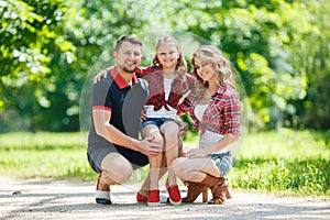 Happy family on a walk in Park in the summer.