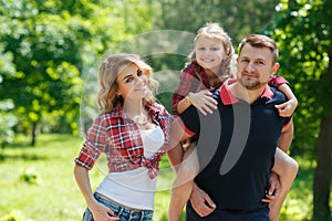 Happy family on a walk in Park in the summer.