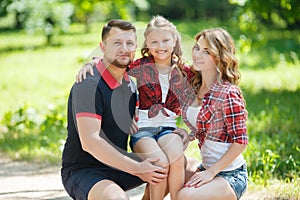 Happy family on a walk in Park in the summer.