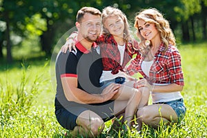 Happy family on a walk in Park in the summer.