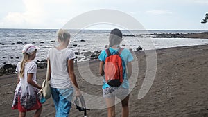 Happy family walking on the beach