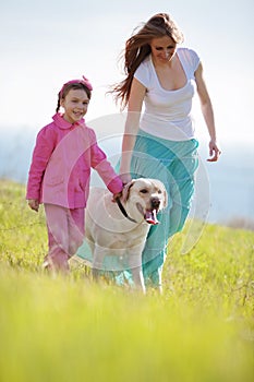 Happy family walking with dog