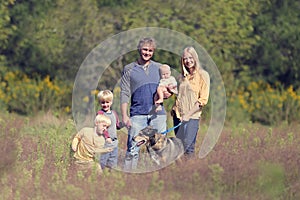 Happy Family Walking Dog In Autumn