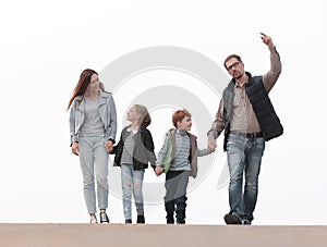 Happy family walking, holding each other`s hands.