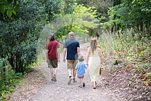 Happy family walking in park